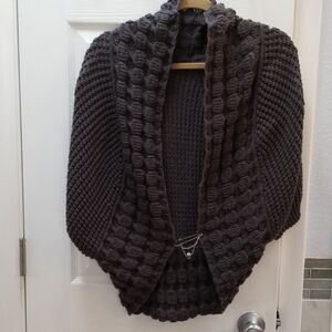 Grey sweater vest with clasp closure embellishment